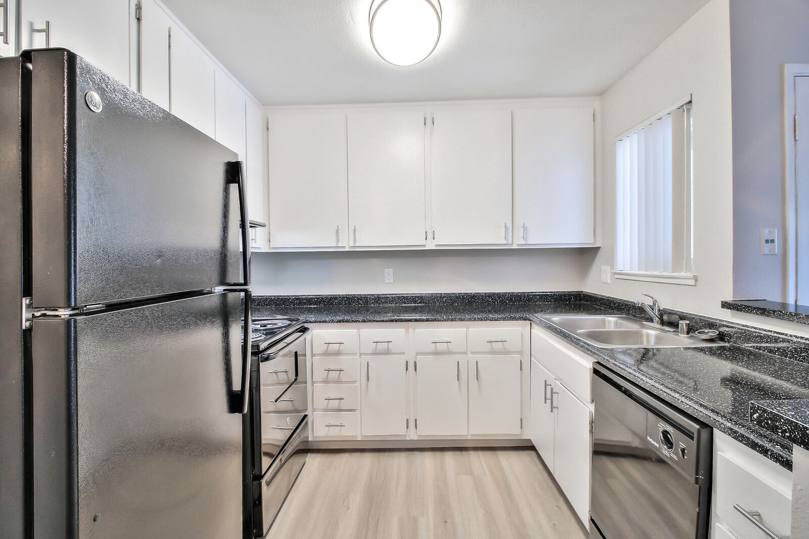 Kitchen with black appliances and countertops