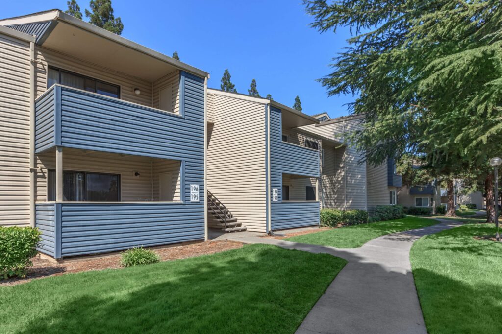Path between residential buildings with large trees
